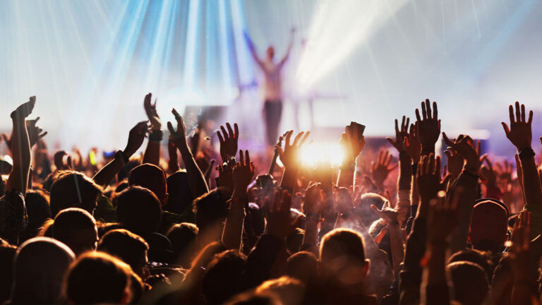 Crowd with hands raised at a live concert