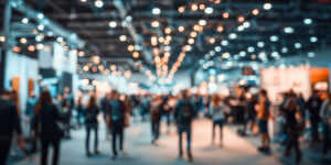 Crowd of attendees walking through a busy convention hall between sessions
