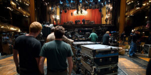 Concert crew resetting the stage and equipment between sets