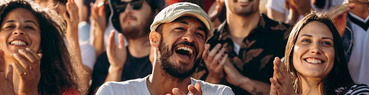 Excited crowd cheering and clapping at a live event